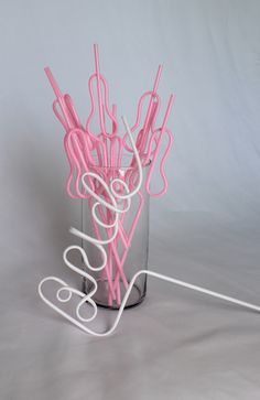 pink and white paper clips in a glass vase