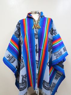 BLUE TONES WITH MULTICOLORED DESIGNS HOODED SHAMAN PONCHO This poncho is made with the Andean Textile handmade with a weaving loom, the fabric is strong and durable. This poncho will fit people's sizes ranging from medium to large. Measurement: 72 X 51 inches (including fringe) Country: Perú Culture: Quechua Material: Alpacryl ( Alpaca and acrylic) Peru Culture, Weaving Loom, Poncho Cape, Loom Weaving, Blue Tones, Alpaca, Loom, Kimono Top, Gender Neutral