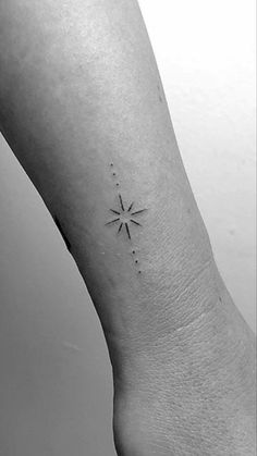 a small star tattoo on the left ankle, with dots and lines coming out of it