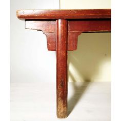 an old wooden table with one leg missing