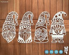 three paper cut out gnomes on a wooden surface