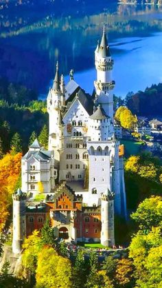 an aerial view of the neusch castle in germany, with autumn foliage surrounding it