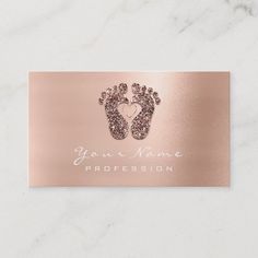 a rose gold foil business card with footprints