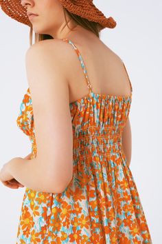 Length: Maxi length. Subcategory: Dress. Sleeves: Adjustable straps. Print: Floral print. Fit: Relaxed fit. Style: Romantic. Detail: Shirred stretch bodice. Fabric: Lightweight woven fabric . Waist: Elastic waist. runs true to size. S. 100% Polyester Summer Floral Print Cami Dress, Orange Floral Print Dress With Spaghetti Straps, Orange Floral Spaghetti Strap Dress, Floral Print Cami Sundress, Summer Ruched Floral Maxi Dress, Summer Floral Maxi Dress With Ruched Details, Floral Beach Dress With Smocked Bodice, Fitted Cami Sundress With Floral Print, Ruched Floral Maxi Dress For Summer