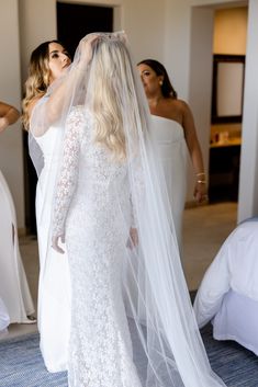 the bride is getting ready to walk down the aisle in her wedding dress and veil