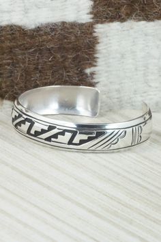 This sterling silver bracelet was made by Navajo silversmith Rosita Singer. The back is signed T&R Singer and stamped sterling.Size: 5 5/8" (will fit a 6 3/4" wrist)Gap: 1 1/8"Length: 1/2"Free shipping on all orders! We ship with USPS and always include tracking. All orders ship within a day of payment.Returns are accepted up to 30 days after you receive your order. Just send us a message. Our shop offers cash back or store credit. The item must be returned in new condition. Southwestern Style Etched Sterling Silver Bracelet, Adjustable Southwestern Sterling Silver Bracelet, Adjustable Etched Sterling Silver Southwestern Bracelet, Adjustable Etched Southwestern Sterling Silver Bracelet, Sterling Silver Southwestern Bracelet, Southwestern Sterling Silver Adjustable Bracelet Stamped, Southwestern Stamped Sterling Silver Adjustable Bracelet, Adjustable Stamped Southwestern Sterling Silver Bracelet, Southwestern Sterling Silver Bracelet