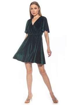 An elegant flutter sleeve skater dress features a fit-and-flare silhouette in soft stretch velvet for feminine style. 36 7/8" length Surplice neck Flutter sleeves Back keyhole with button-loop closure Elasticized waist Velvet construction Flared silhouette Shell: 96% polyester, 4% spandex Lining: 100% polyester Hand wash cold, line dry Imported Casual Flutter Sleeve Dress For Evening, Fitted Flutter Sleeve Dresses For Fall, Chic Green Dress With Butterfly Sleeves, Casual Party Dress With Flutter Sleeves, Casual Party Dress With Butterfly Sleeves, Flounce Skirt, Flutter Sleeve Dress, Stretch Velvet, Sweaters And Leggings