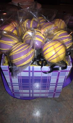 purple and yellow striped cake balls in a basket