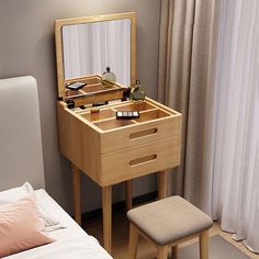 a bedroom with a bed, dressing table and mirror on it's side in front of a window