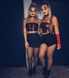 two women dressed up in costumes standing next to each other with their faces painted on