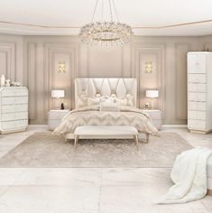 a large white bed sitting in a bedroom next to a chandelier and two lamps