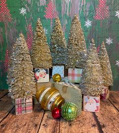 small christmas trees and presents on a wooden table