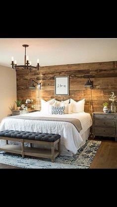 a bedroom with a large bed and wooden headboard on the wall, along with a bench