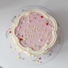 a pink birthday cake with the words happy birthday pera on it's frosting