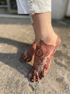 a woman's feet with hennap on it