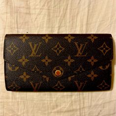 Like New Lv Sarah Wallet 7.5 X 3.9 Inches (Length X Height) Like New - Barely Used - Sold Purse That I Purchased It For. Monogram Coated Canvas, Brown Grained Cowhide-Leather Lining, Gold-Color Hardware Still Shiny, Press-Stud Closure. 2 Large Gusseted Compartments, Zipped Coin Pocket, Inside Flat Pocket, Outside Flat Pocket, 16 Card Slots. Could Add A Non-Branded Chain To Make This A Crossbody. Made In France, Microchipped No Date Code. Smoke Free Home. Did Not Keep The Box Or Dust Cover So It Comes With Nothing. Authentic! Buy With Confidence!! Poshmark Will Authenticate This Item For You! Louis Vuitton Sarah Wallet, Chain Scarf, Dust Cover, Press Studs, Long Wallet, Authentic Louis Vuitton, Cowhide Leather, Made In France, Louis Vuitton Bag