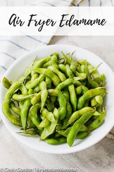 a white bowl filled with green beans and the words air fryer edamame