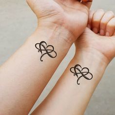 two people with matching tattoos on their arms