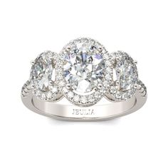 a three stone diamond ring set in 18k white gold with diamonds surrounding the band