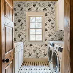 a washer and dryer in a room with floral wallpaper on the walls