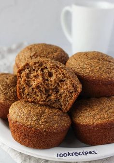 a white plate topped with muffins next to a cup