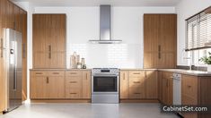 a modern kitchen with wood cabinets and stainless steel appliances, including a range hood over the stove