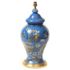 a blue and gold urn sitting on top of a table