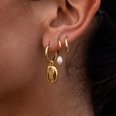 Introducing the Essential Huggie - a timeless essential with a subtle twist. These classic gold huggie earrings stand out with a unique feature: a slight curve in the circle that adds an extra dimension of elegance. Perfect for everyday wear, the Essential Huggie is beautiful on its own or stacked with other earrings. Luxury Hammered Gold Huggie Earrings, Luxury Hammered Huggie Earrings, Earrings Stand, Gold Huggie Earrings, Necklace Extender, Earring Stand, Gold Piece, Huggie Earrings, Classic Gold