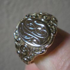 Such a beautiful ring for they guys but could be sized down for the ladies, within reason. This ring has fabulous scroll detailing on the shoulders. The oval face area is approx. 5/8 inches long and under 1/2 inch wide. Marks are the back 10 k and tested as such. Ring is heavy at 8.8 grams and approx. a size 13. This ring has been size up in the past. You can feel a slight ripple in the band in back as well as it being a bit thinner. Not an issue but an observation. The initials on the face look Victorian 14k Gold Signet Ring With Polished Finish, Oval Engraved Signet Ring For Collectors, Victorian 14k Gold Signet Ring With Initials, Antique Signet Ring With Initials For Formal Events, Victorian Engraved Ring With Polished Finish In 14k Gold, Victorian Engraved Ring With Polished Finish, Victorian Oval Signet Ring With Polished Finish, Antique Engraved Ring With Polished Finish For Formal Occasions, Victorian Hallmarked Initial Ring For Formal Occasions