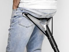 a person holding an electric toothbrush in their back pocket with his pants folded down