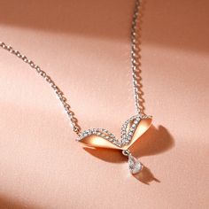 A whimsical look, this darling butterfly pendant gives her wings to fly. Fashioned in warm rose-gold tone silver, this simple and sweet butterfly is finished with a polished shine and wings encrusted with sparkling white stones, with a shiny pear-cut stone hanging. It will be eye-catching and attractive when someone wears this delightful necklace. The simple design with the innovative elements is an ideal purchase for Christmas, Mothers Day, Valentines Day, birthday gifts for her.Carat Weight: 1 Elegant Silver Butterfly Necklace With Cubic Zirconia, Elegant Silver Butterfly Necklace In Cubic Zirconia, Elegant White Sterling Silver Butterfly Necklace, Elegant White Gold Butterfly Pendant Necklace, Dainty Rose Gold Butterfly Pendant Necklace, Rose Gold Butterfly Pendant Necklace With Delicate Chain, Elegant Silver Butterfly Necklace, Elegant Silver Butterfly Necklace With Butterfly Clasp, Rose Gold Butterfly Pendant Necklace