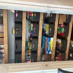 an organized pantry with bins and shelves filled with food, snacks, and other items