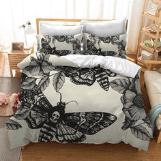 a bed with black and white butterflies on it