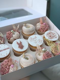 a box filled with lots of cupcakes on top of a white countertop