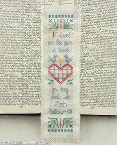 a cross stitch bookmark with the words, i love you and two hearts on it