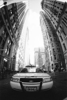 a police car parked in front of tall buildings