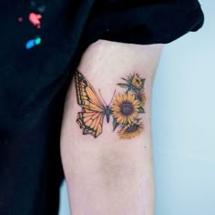 a butterfly and sunflower tattoo on the leg