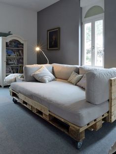 a couch made out of wooden pallets in a living room