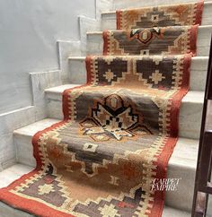 a carpeted stair case with rugs on it