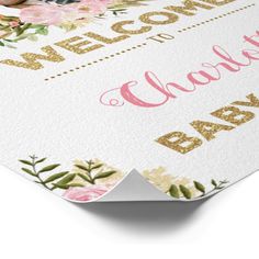 a welcome baby card with pink and gold flowers