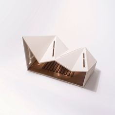 an architectural model of a house with three windows and two roof sections on top of each other