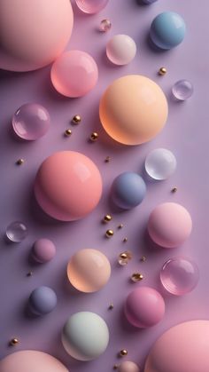 many different colored balls and bubbles on a purple surface