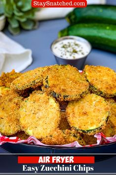 air fryer fried zucchini chips in a bowl with sauces on the side