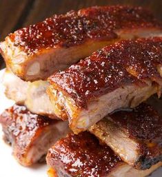 ribs covered in bbq sauce on a white plate