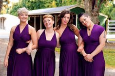 four women in purple dresses posing for the camera