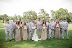 a group of people in formal wear posing for a photo