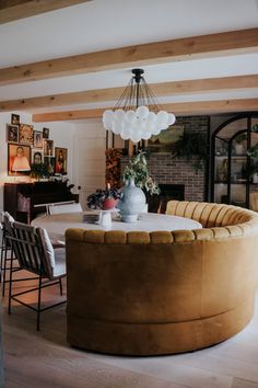 a living room filled with furniture and a large round table