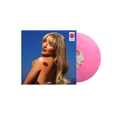 a pink vinyl record with a woman's face painted on it