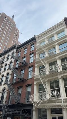 the fire escape is located on the side of the building in front of the other buildings