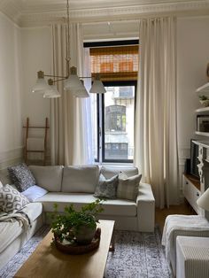 a living room filled with furniture and a window